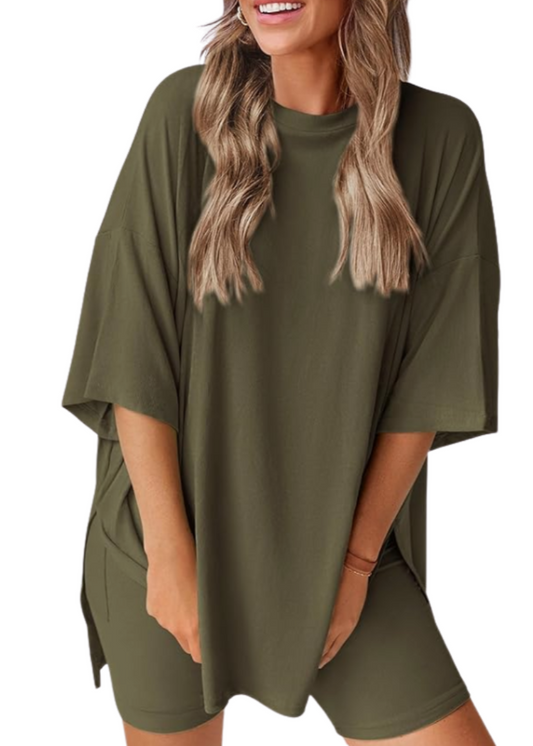 Woman wearing an olive green outfit with a matching top and shorts on a white background